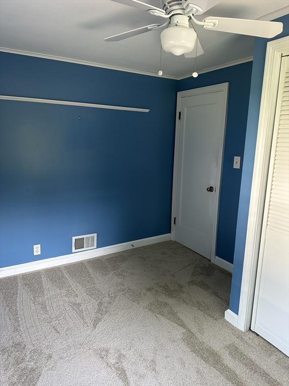 40 Elmwood Cir, Peabody, MA 01960 - carpeted empty room featuring baseboards, a ceiling fan, and crown molding