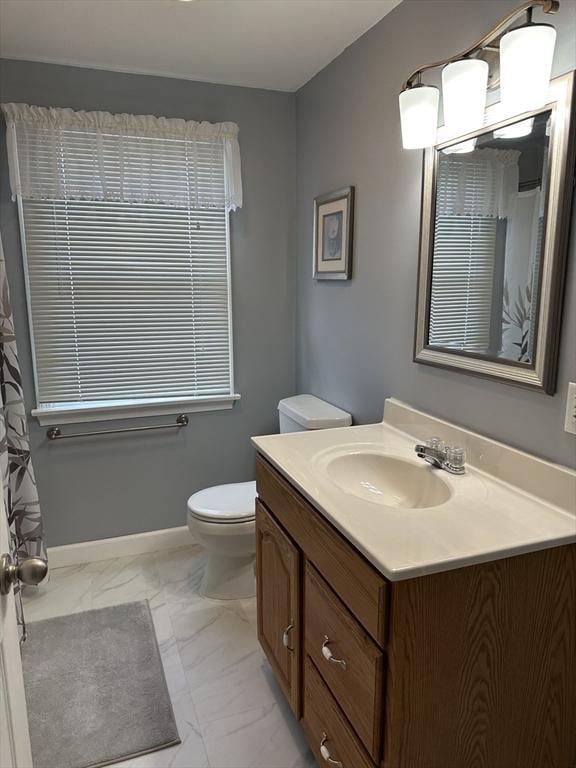 40 Elmwood Cir, Peabody, MA 01960 - bathroom featuring marble finish flooring, vanity, toilet, and baseboards