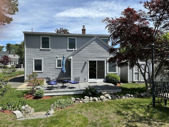 40 Elmwood Cir, Peabody, MA 01960 - back of property with a chimney, a deck, and a lawn