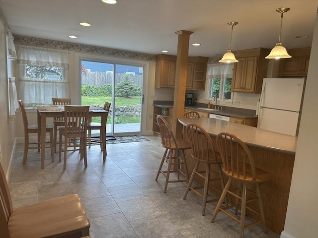 40 Elmwood Cir, Peabody, MA 01960 - kitchen with freestanding refrigerator, a sink, plenty of natural light, a breakfast bar, and recessed lighting
