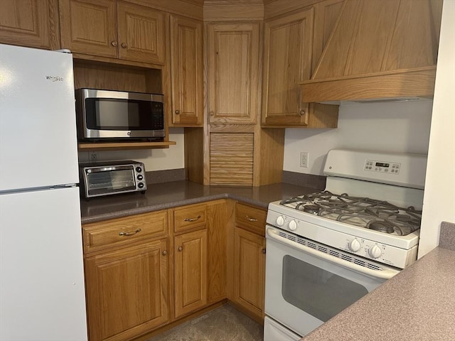 40 Elmwood Cir, Peabody, MA 01960 - kitchen with white appliances, custom exhaust hood, dark countertops, and brown cabinets