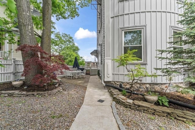 388 Arborway, Boston, MA 02130 - view of side of property with board and batten siding and a patio area