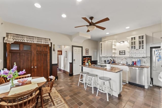 388 Arborway, Boston, MA 02130 - kitchen with stainless steel dishwasher, a ceiling fan, open shelves, backsplash, and a sink
