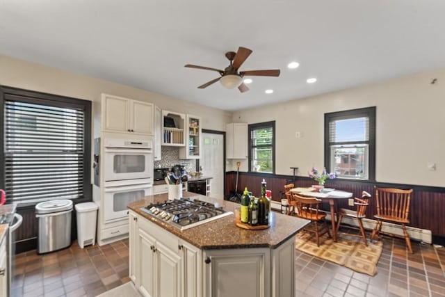 388 Arborway, Boston, MA 02130 - kitchen featuring double oven, stainless steel gas stovetop, a ceiling fan, a wainscoted wall, and recessed lighting