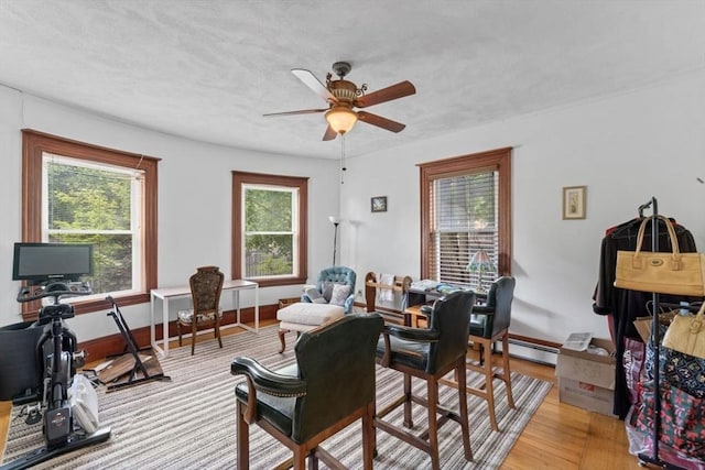 388 Arborway, Boston, MA 02130 - dining area featuring a baseboard heating unit, a ceiling fan, light wood-type flooring, and baseboards