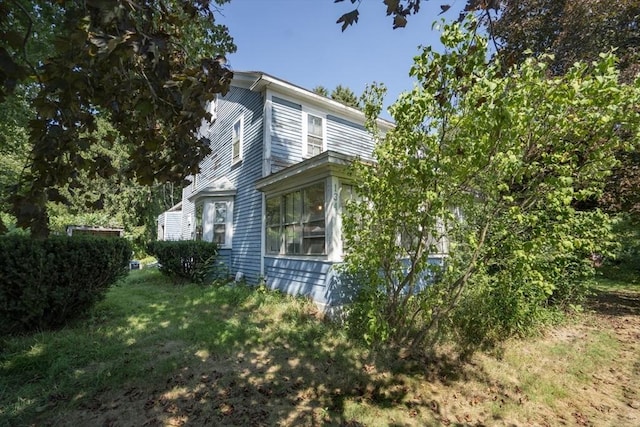 view of home's exterior featuring a lawn