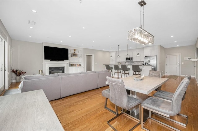 2 Inwood Dr Unit 3003, Woburn, MA 01801 - dining space featuring light wood-style floors, recessed lighting, a glass covered fireplace, and baseboards