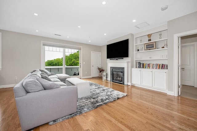 2 Inwood Dr Unit 3003, Woburn, MA 01801 - living room featuring light wood-type flooring, a glass covered fireplace, built in features, baseboards, and recessed lighting