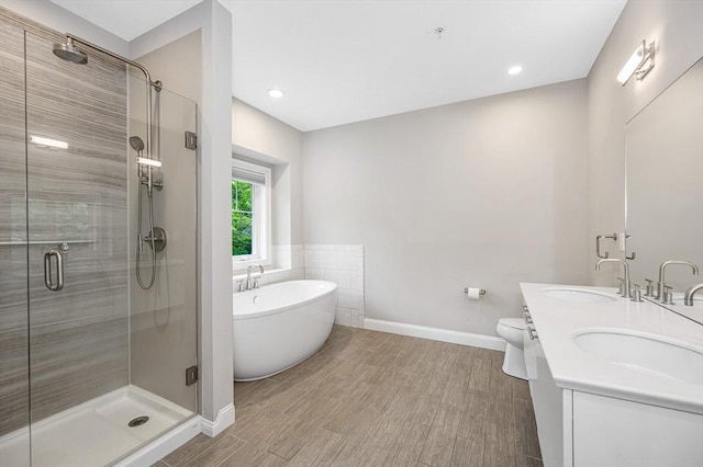 2 Inwood Dr Unit 3003, Woburn, MA 01801 - bathroom featuring a shower stall, a soaking tub, baseboards, double vanity, and wood finished floors