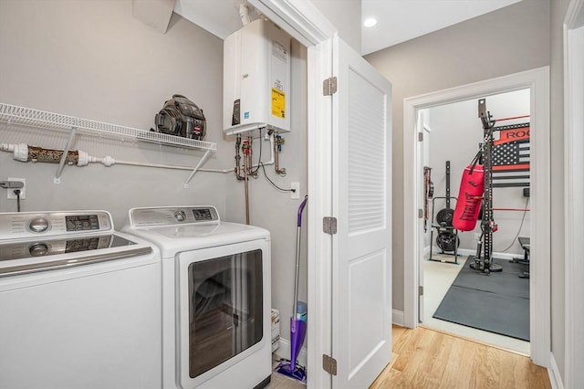 2 Inwood Dr Unit 3003, Woburn, MA 01801 - washroom with washing machine and clothes dryer, tankless water heater, and light wood-style flooring