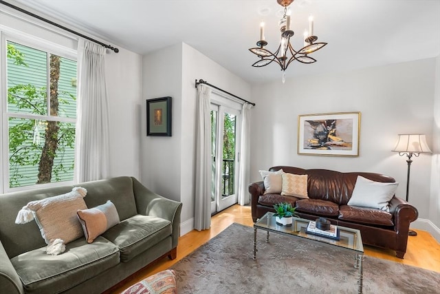 26-B Lake St Unit 26B, Somerville, MA 02143 - living area with a chandelier, baseboards, and wood finished floors
