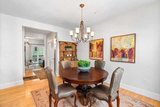 26-B Lake St Unit 26B, Somerville, MA 02143 - dining space with a chandelier, light wood-style floors, and baseboards