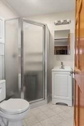 16 Simmons Rd, Nahant, MA 01908 - bathroom featuring a stall shower, vanity, toilet, and tile patterned flooring