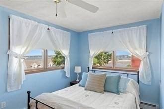 16 Simmons Rd, Nahant, MA 01908 - bedroom with a ceiling fan, multiple windows, and a baseboard radiator