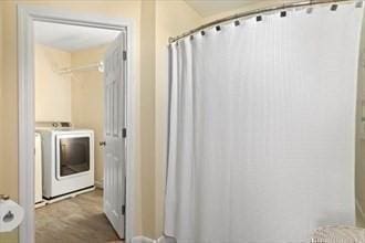 16 Simmons Rd, Nahant, MA 01908 - full bathroom featuring washing machine and dryer and a shower with shower curtain