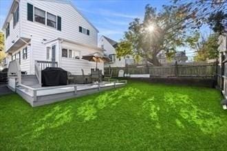16 Simmons Rd, Nahant, MA 01908 - rear view of house with a yard, fence, and a wooden deck