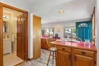 16 Simmons Rd, Nahant, MA 01908 - kitchen featuring brown cabinetry, a kitchen bar, and recessed lighting