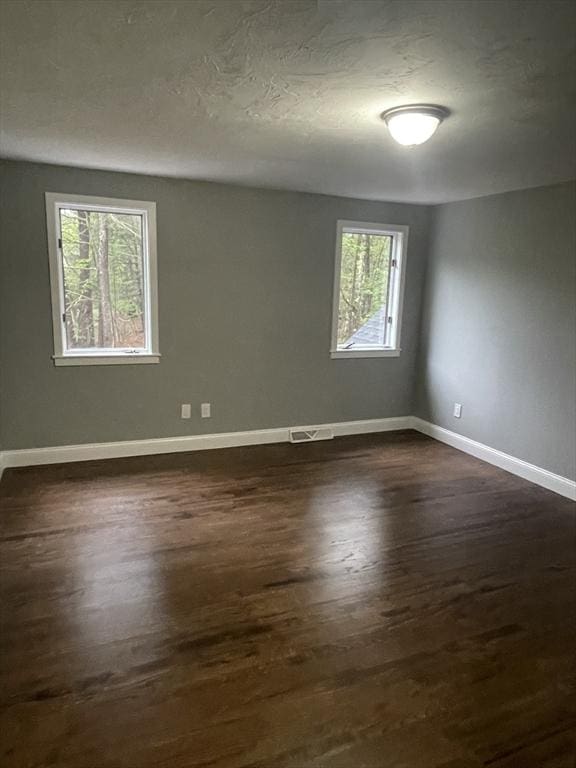 47 Woodcock Ln, Marlborough, MA 01752 - spare room with dark wood finished floors and baseboards
