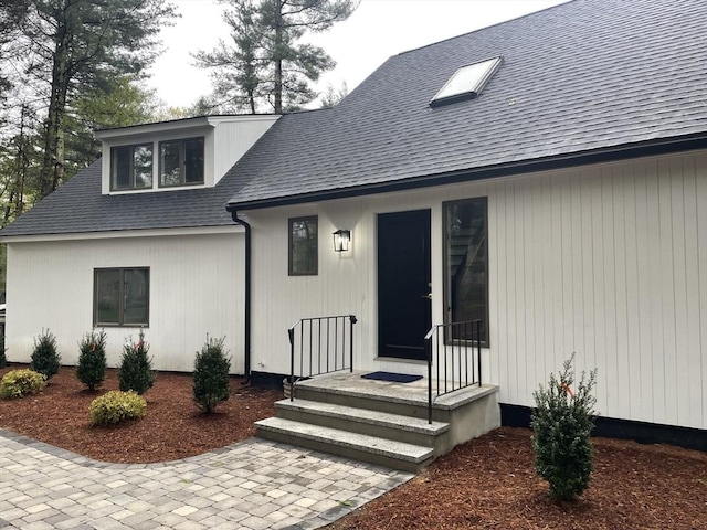 47 Woodcock Ln, Marlborough, MA 01752 - view of exterior entry with a shingled roof