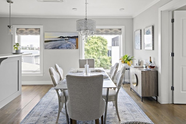 3 Ardee St Unit 3, Boston, MA 02128 - dining space with wood finished floors, a chandelier, crown molding, and baseboards