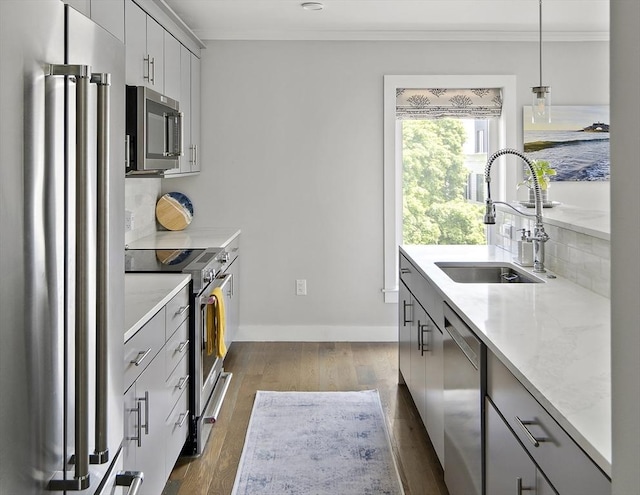 3 Ardee St Unit 3, Boston, MA 02128 - kitchen featuring appliances with stainless steel finishes, a sink, ornamental molding, gray cabinetry, and dark wood finished floors