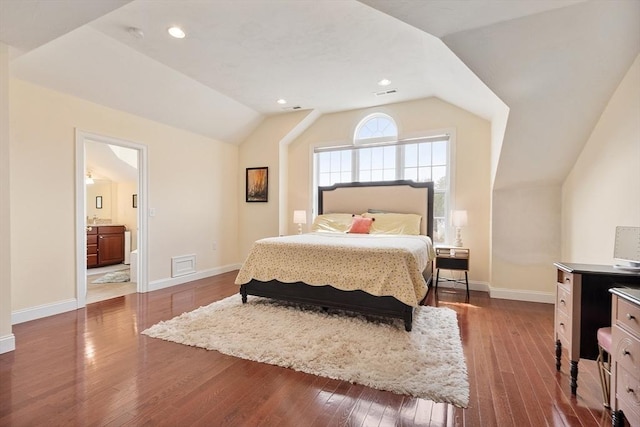 bedroom featuring baseboards, dark wood finished floors, visible vents, and vaulted ceiling
