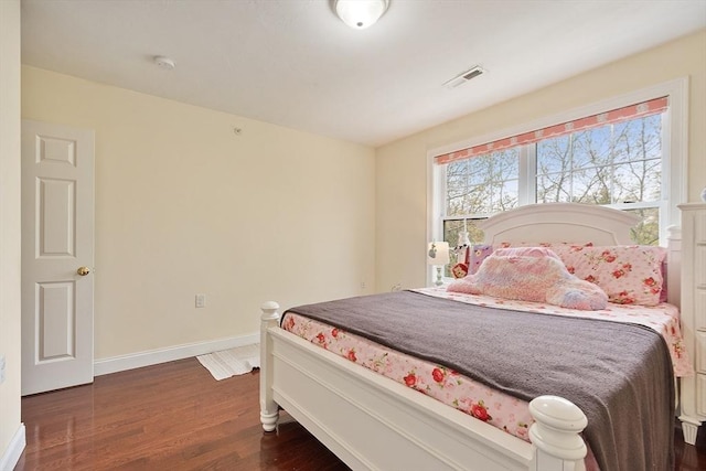 bedroom with baseboards, dark wood-type flooring, and visible vents
