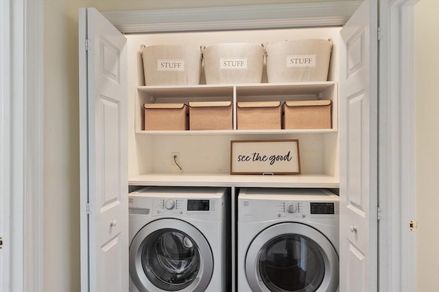 washroom with washing machine and clothes dryer and laundry area