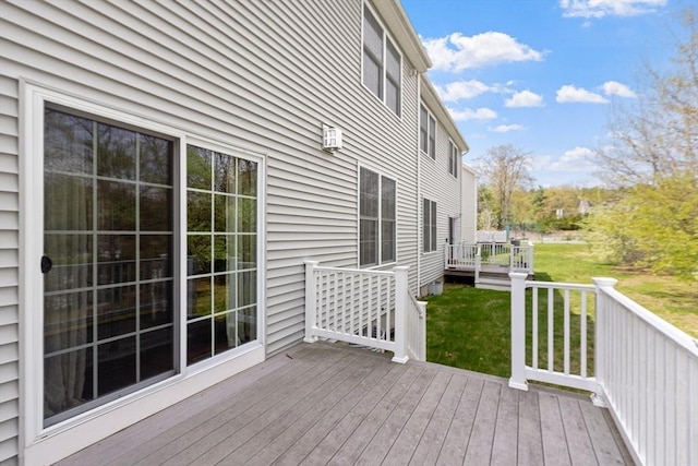 wooden deck featuring a yard