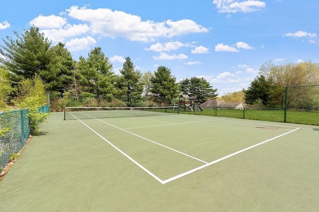 view of tennis court with fence and community basketball court