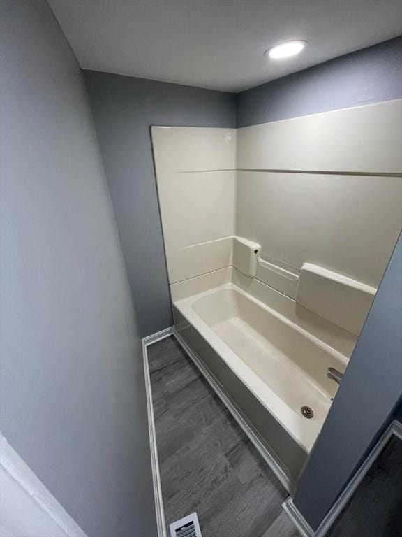 7 Coolidge St, Hudson, MA 01749 - bathroom with a tub to relax in, wood finished floors, and recessed lighting