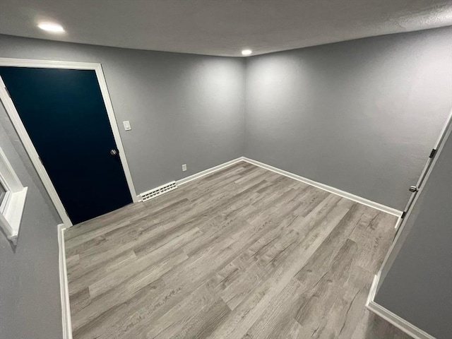 7 Coolidge St, Hudson, MA 01749 - empty room featuring wood finished floors, recessed lighting, and baseboards
