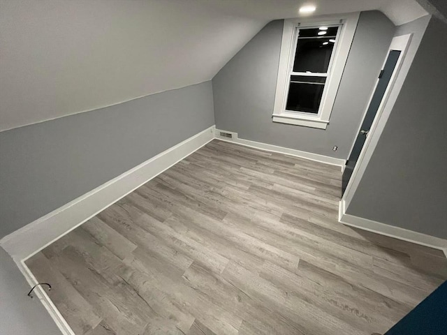 7 Coolidge St, Hudson, MA 01749 - additional living space with wood finished floors, lofted ceiling, and baseboards