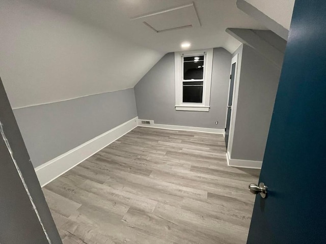 7 Coolidge St, Hudson, MA 01749 - bonus room featuring wood finished floors, attic access, baseboards, and lofted ceiling