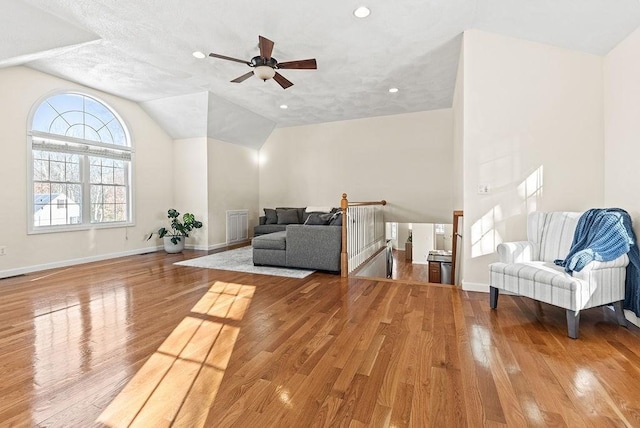 sitting room with lofted ceiling and light wood-type flooring