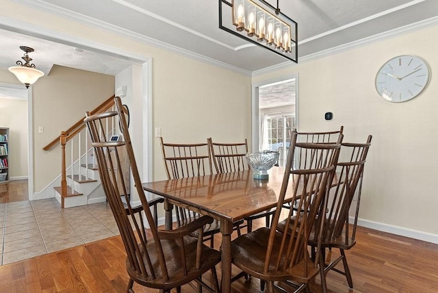 dining room featuring an inviting chandelier, hardwood / wood-style flooring, and ornamental molding