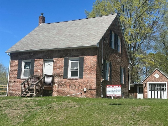 88 Newell St, Chicopee, MA 01013 - view of front of home featuring a chimney, a front lawn, and brick siding