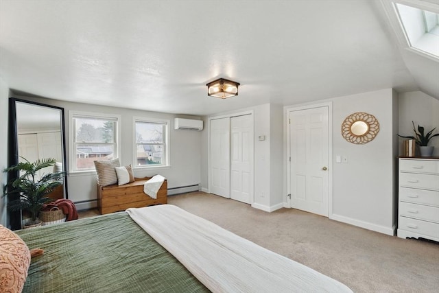 carpeted bedroom featuring a baseboard heating unit, a closet, a wall mounted air conditioner, and baseboards