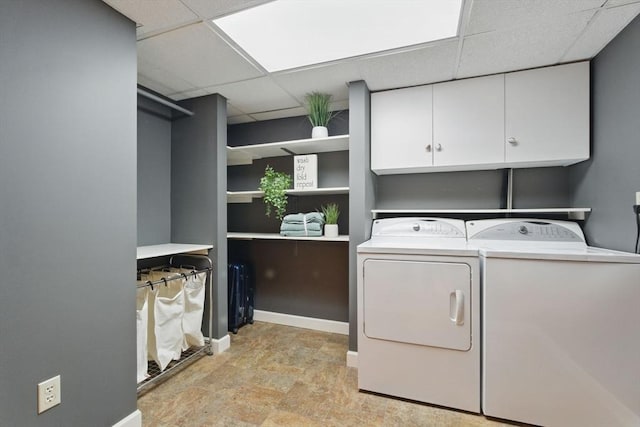 clothes washing area with cabinet space and washer and dryer