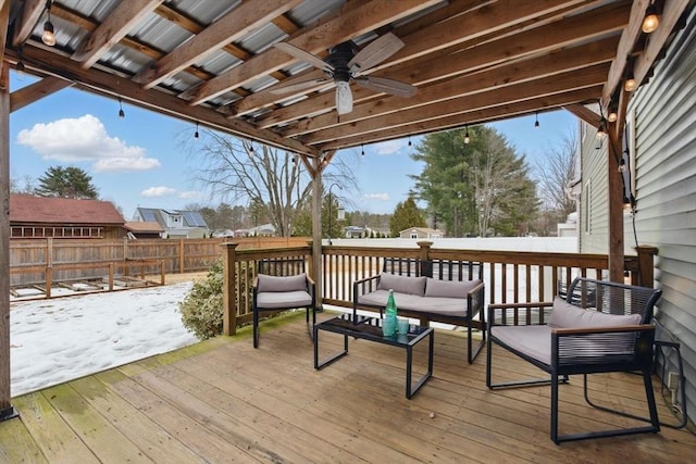 wooden terrace with an outdoor hangout area, a fenced backyard, and a ceiling fan