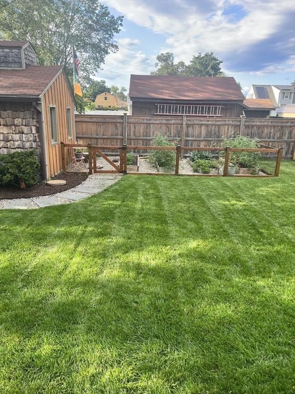 view of yard featuring a vegetable garden and fence