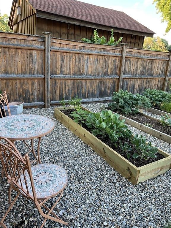 view of yard featuring fence and a garden