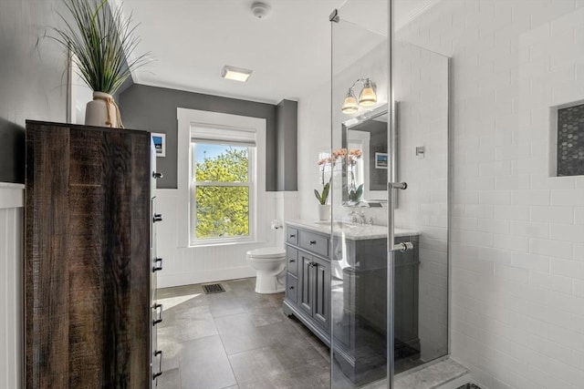 75 Puritan Rd Unit B, Swampscott, MA 01907 - bathroom featuring vanity, wainscoting, toilet, a tile shower, and tile patterned floors