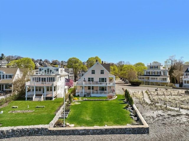75 Puritan Rd Unit B, Swampscott, MA 01907 - back of house featuring a balcony, a lawn, and a residential view