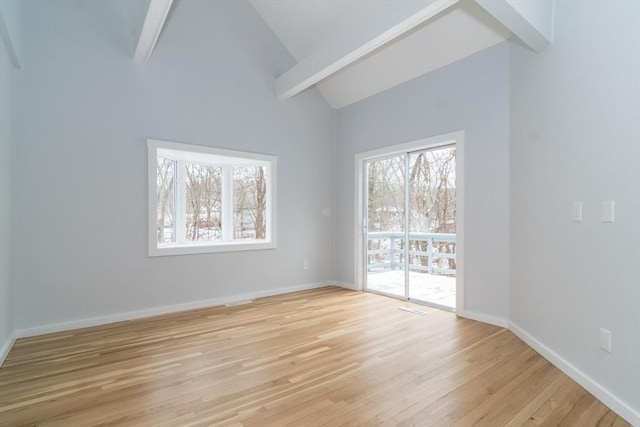 unfurnished room featuring light wood-type flooring, high vaulted ceiling, and beamed ceiling