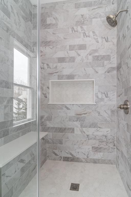 bathroom with tiled shower