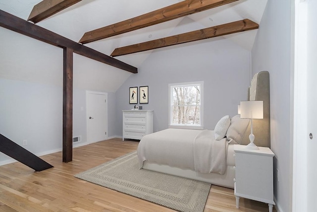 bedroom featuring lofted ceiling and light wood-type flooring