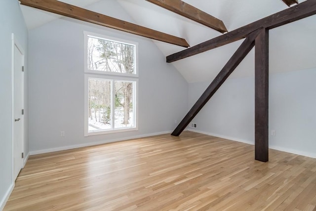 unfurnished living room featuring high vaulted ceiling and light hardwood / wood-style floors