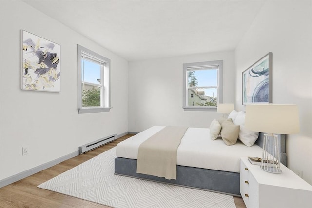 8 Lafayette Park Unit 9, Lynn, MA 01902 - bedroom with a baseboard heating unit, multiple windows, and wood finished floors