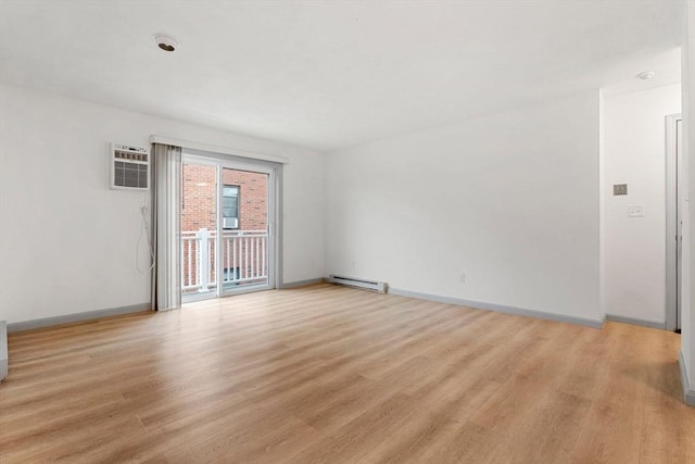8 Lafayette Park Unit 9, Lynn, MA 01902 - spare room featuring baseboard heating, light wood-style flooring, and a wall unit AC